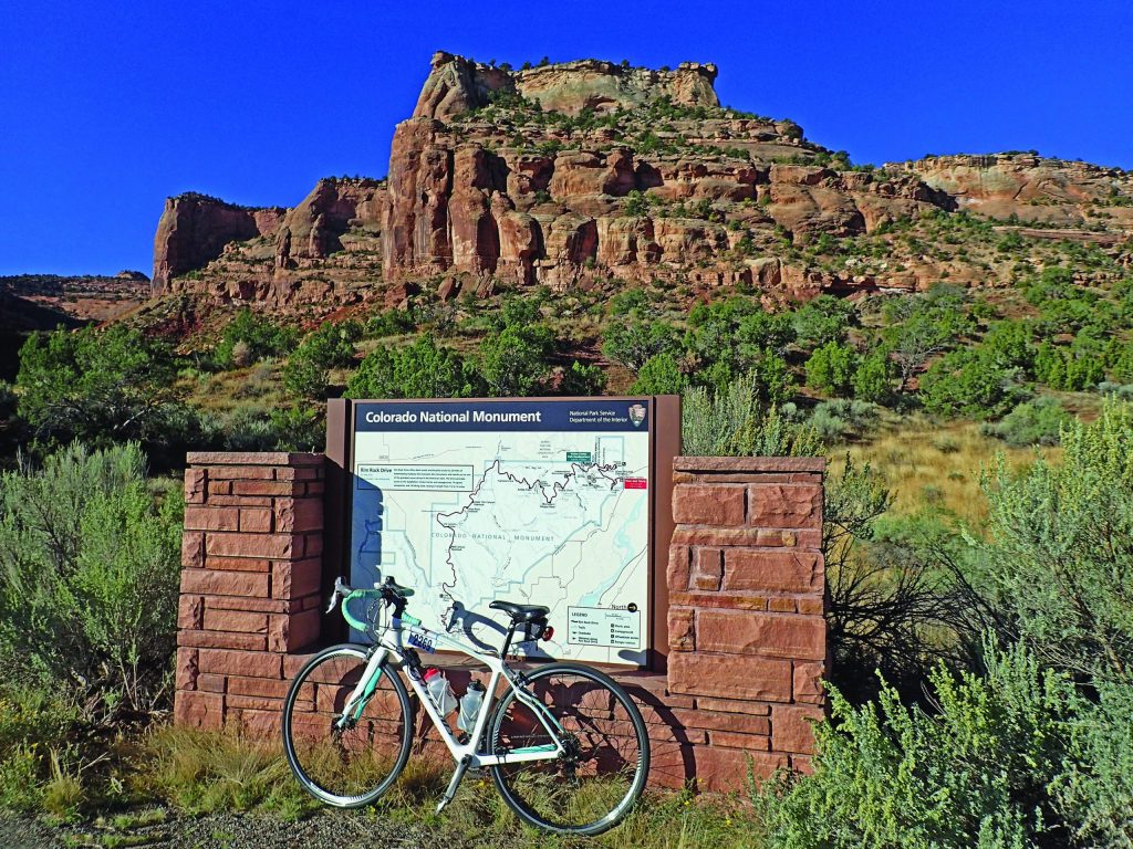 A photo a bike leaning against an info sign for the National Monument in Grand Junction, Colorado